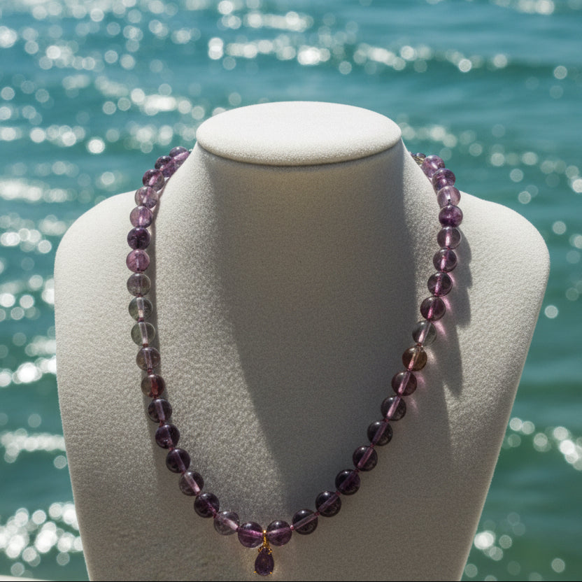 Necklace with gradient fluorite purple beads on a mannequin bust